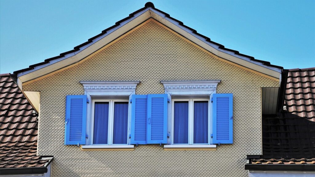 Attic windows with blue shutters