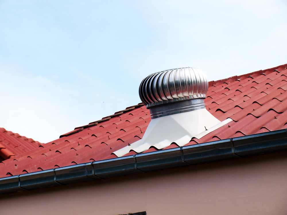 Attic fan on the red roof
