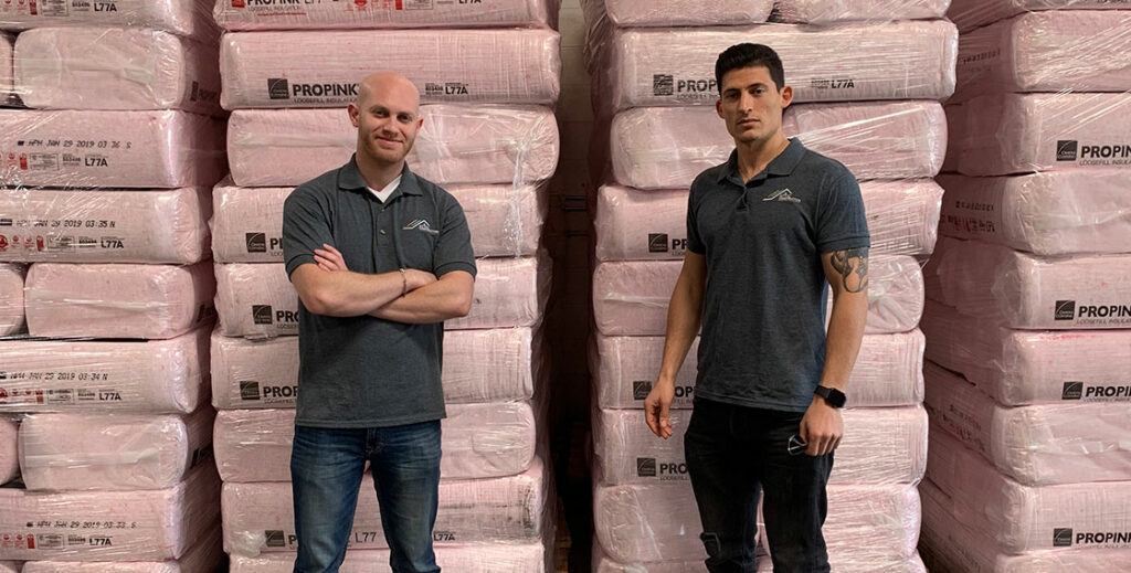 team in front of insulation
