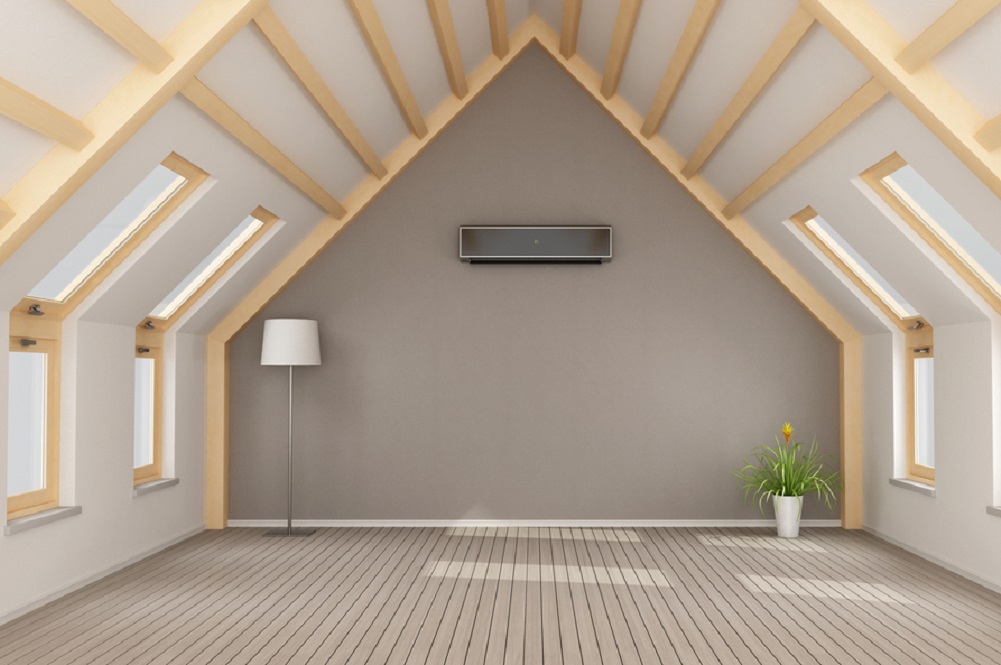 Modern attic without furniture and black air-conditioner on wall
