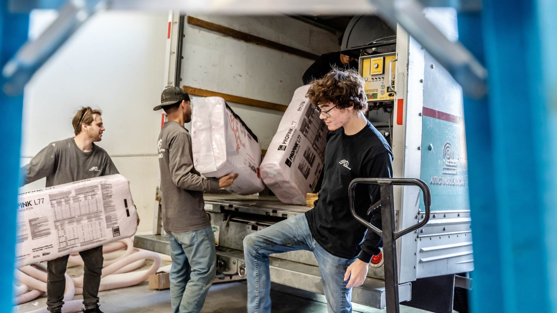 attic construction workers loading truck