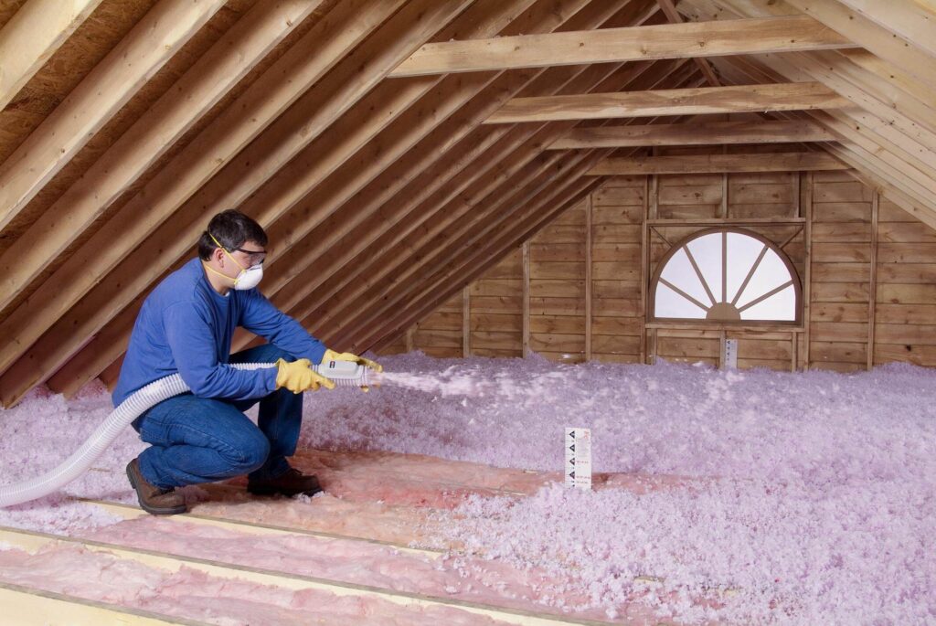 Blowing-Insulation-in-an-unfinished-attic-1